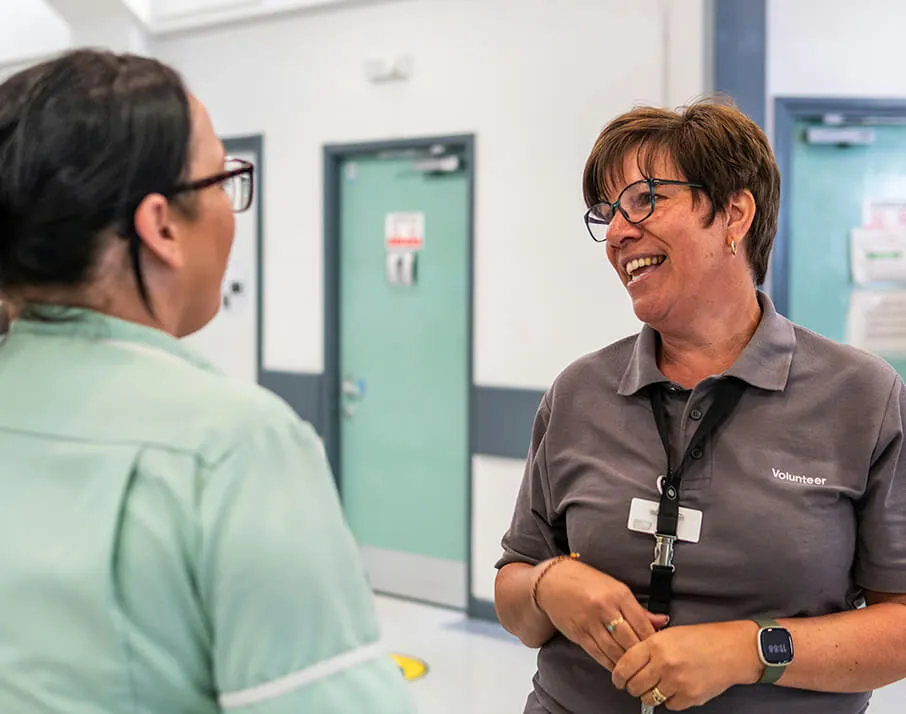 Volunteer talking to nurse