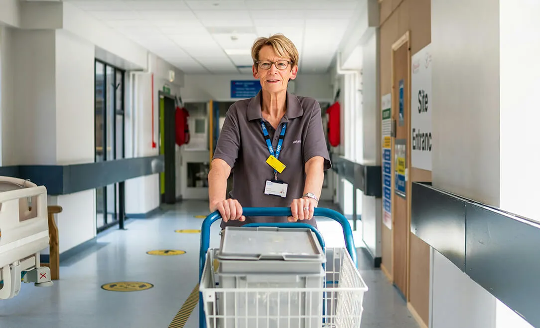 Hospital volunteer pushing cart