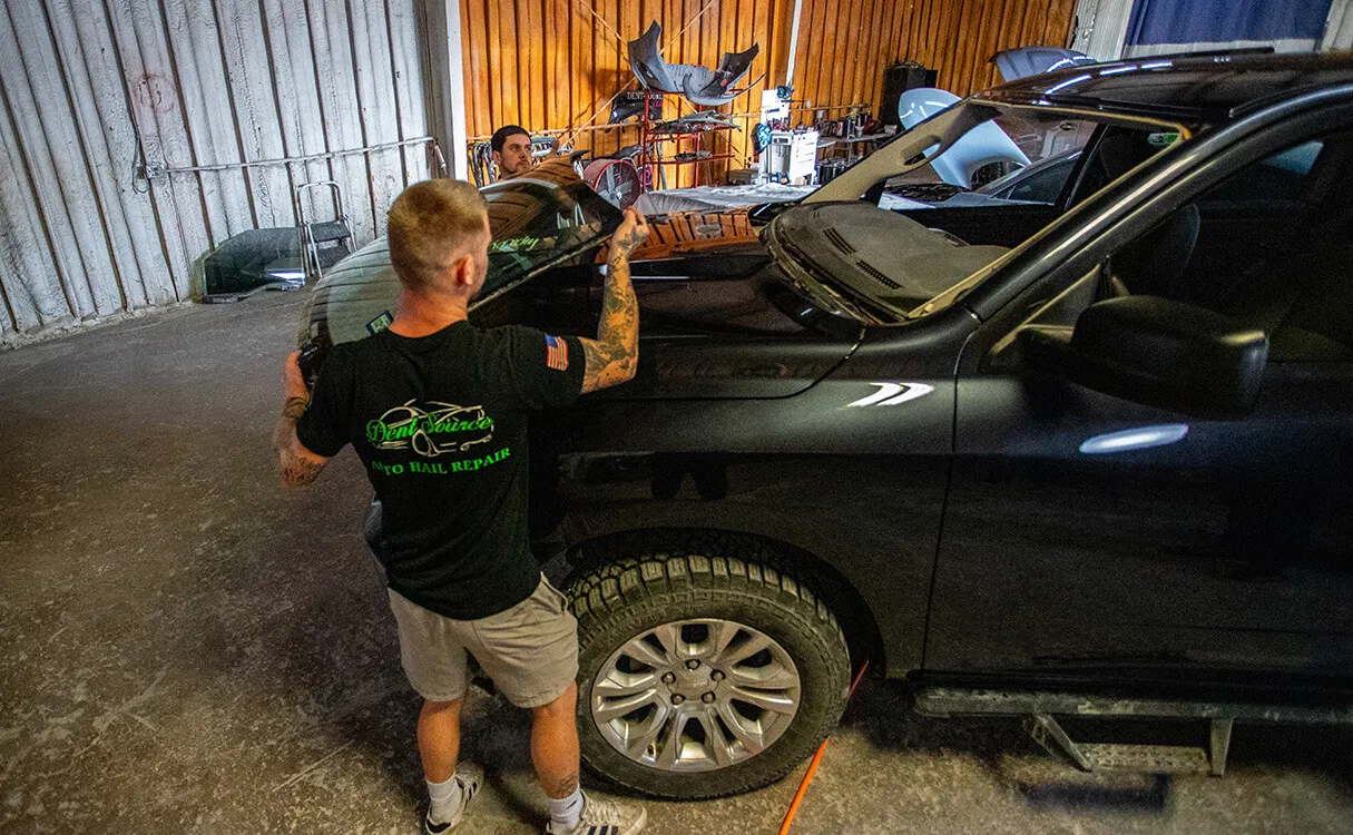 Team replacing windshield